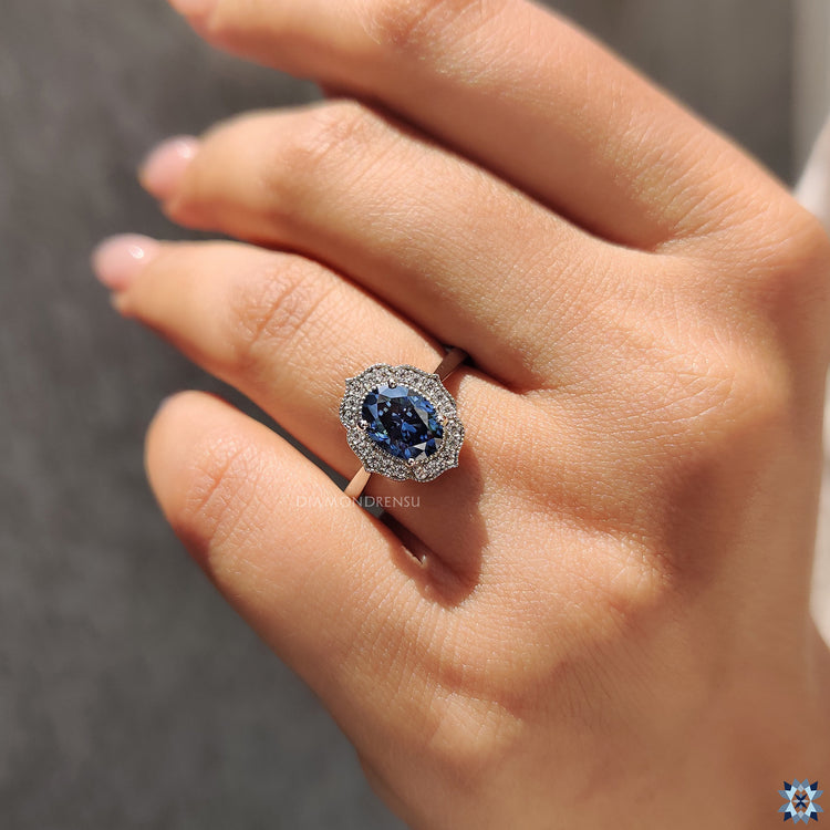 Oval Moissanite engagement ring in 4 prong setting with vintage milgrain details.