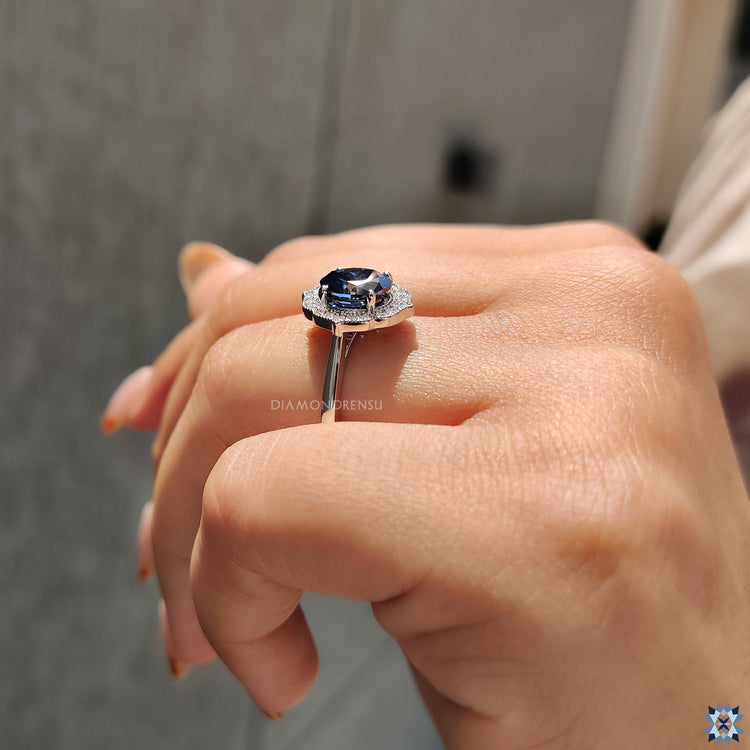 Handmade jewelry featuring oval cut Moissanite in halo setting with white gold band.