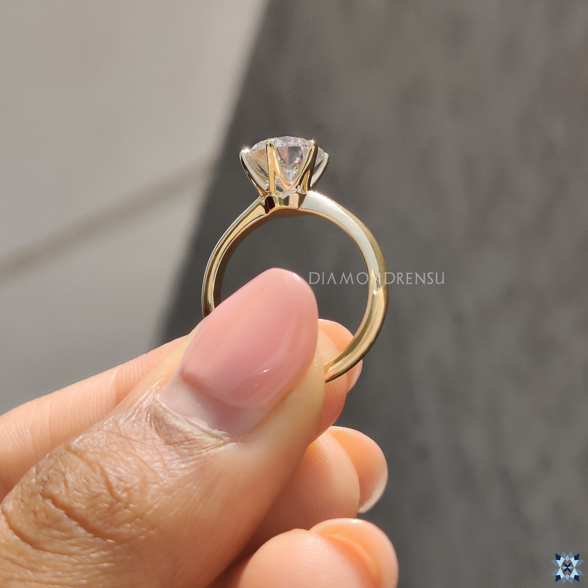 Diamondrensu UK engagement ring with solitaire setting and knife edge band.