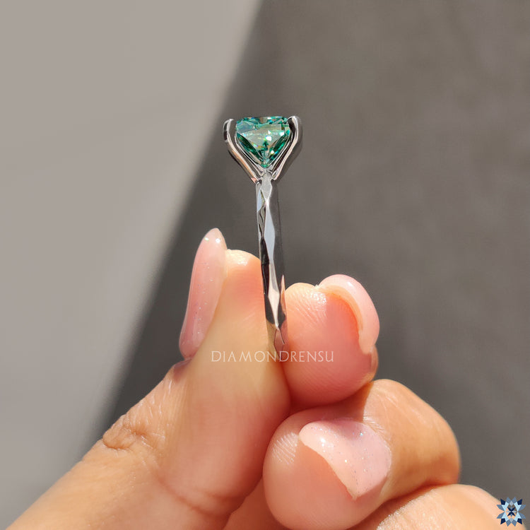 Cyan blue moissanite engagement ring with handcrafted solitaire finish.