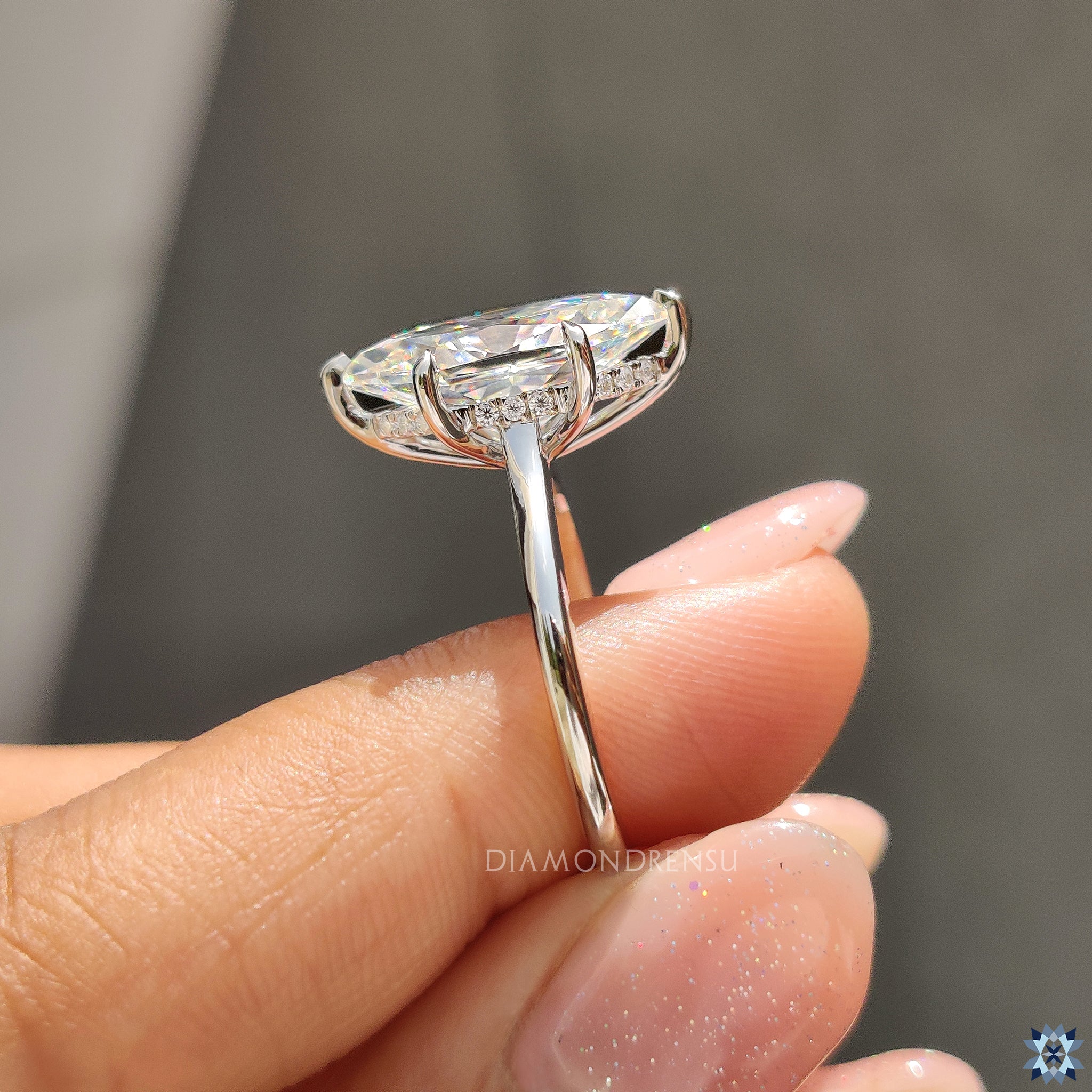 UK engagement ring in white gold with Dutch marquise Moissanite and 6 prong setting.