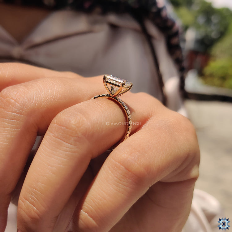 Moissanite for an engagement ring in yellow gold with round cut pave setting.