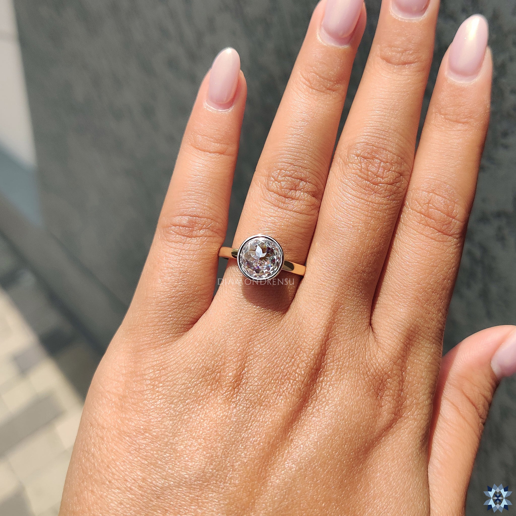 Simple bezel solitaire ring featuring round rose cut Moissanite for classic elegance.