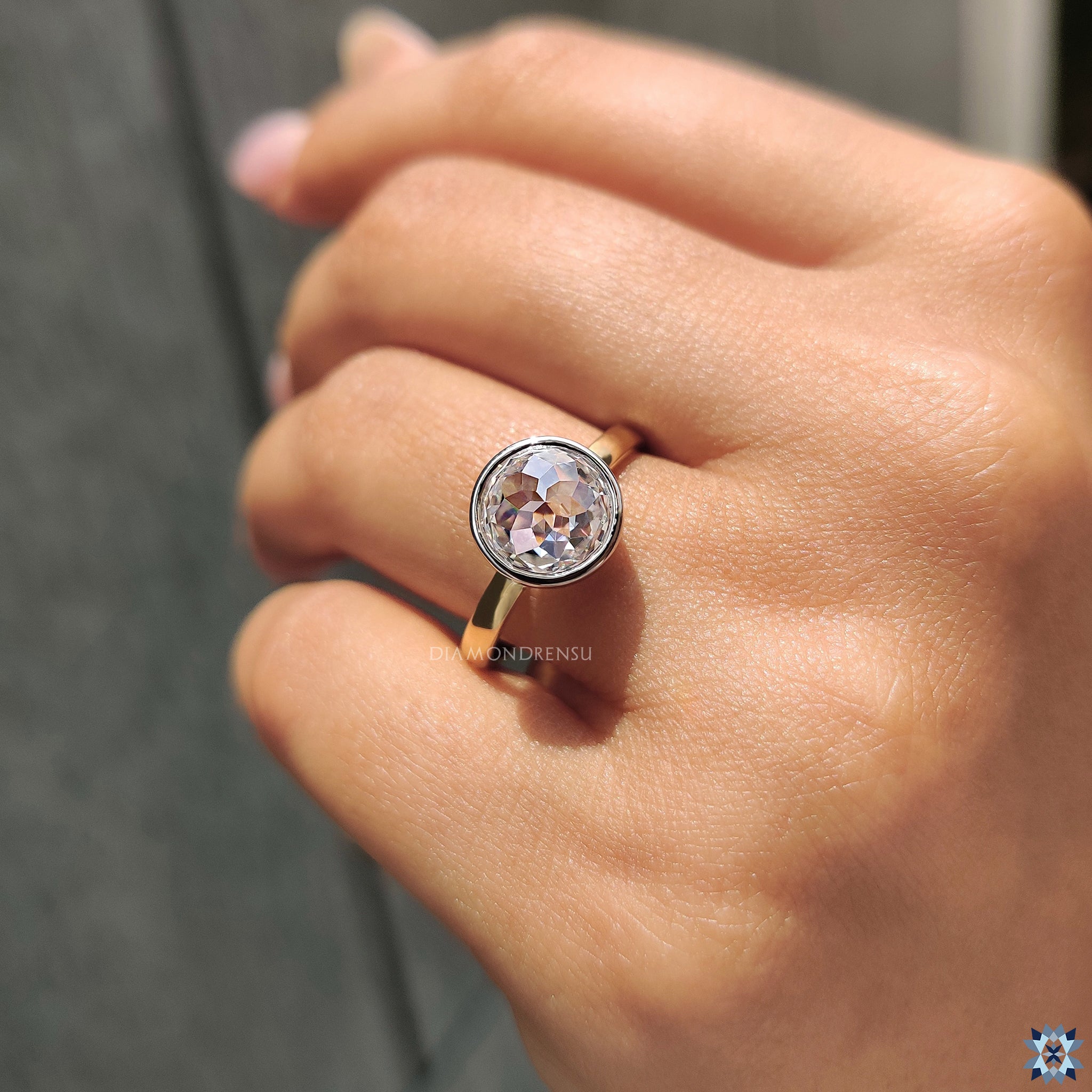 Moissanite for an engagement ring featuring bezel setting and round rose cut stone.