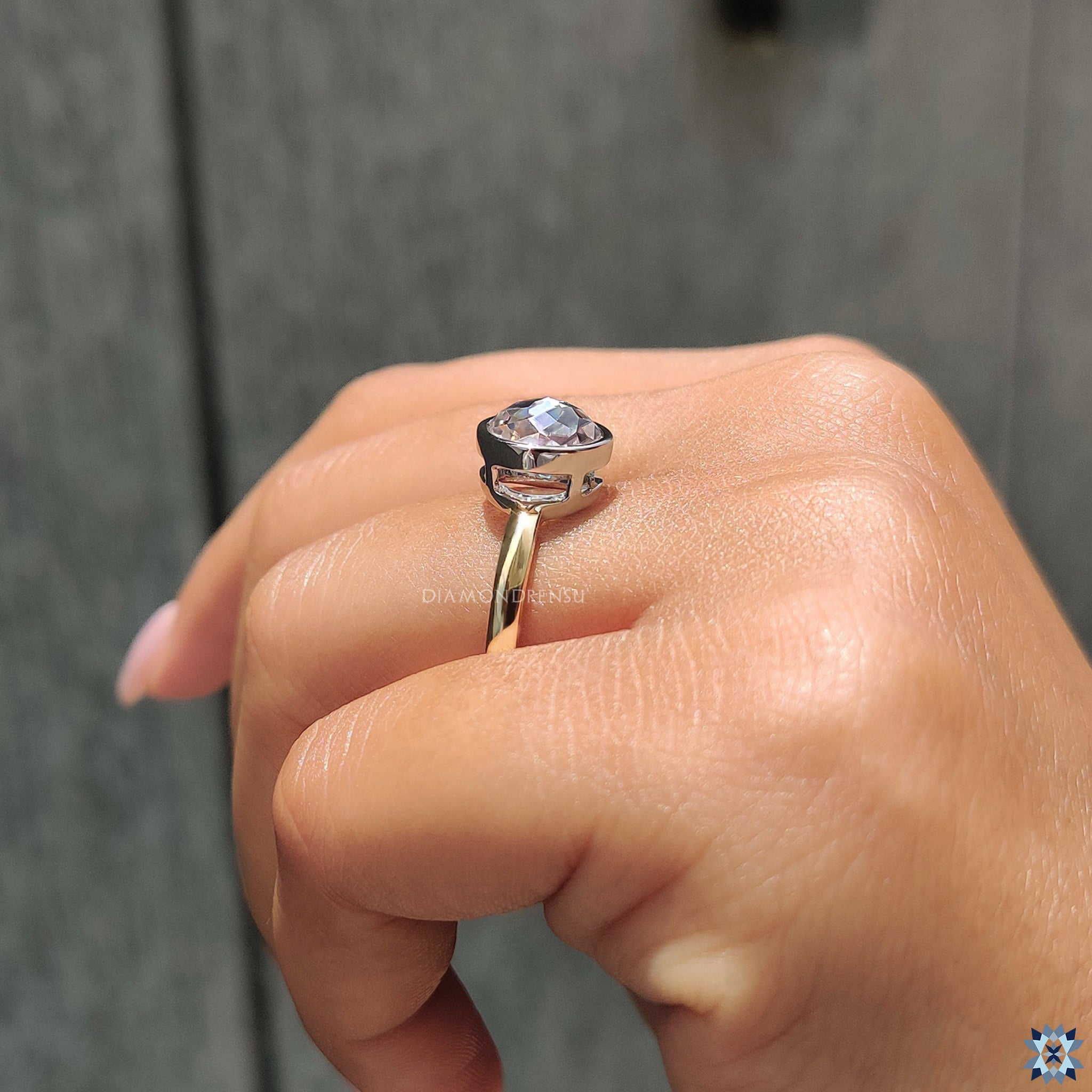 Simple engagement ring with round rose cut Moissanite and two-tone gold finish.