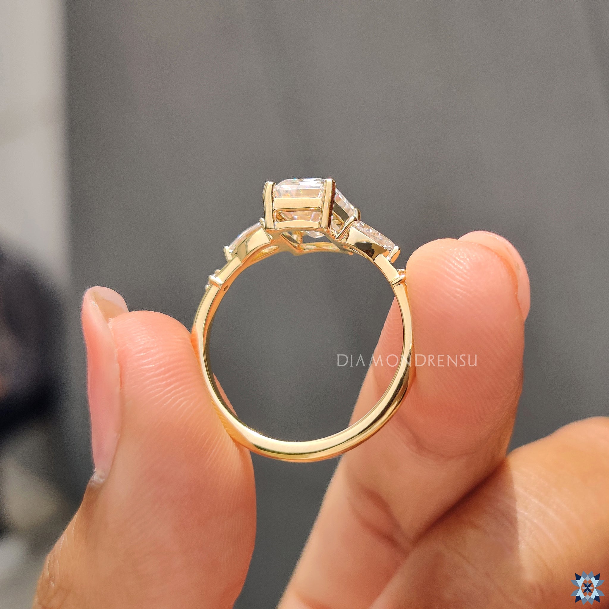 Moissanite for an engagement ring with elegant emerald and pear stones.