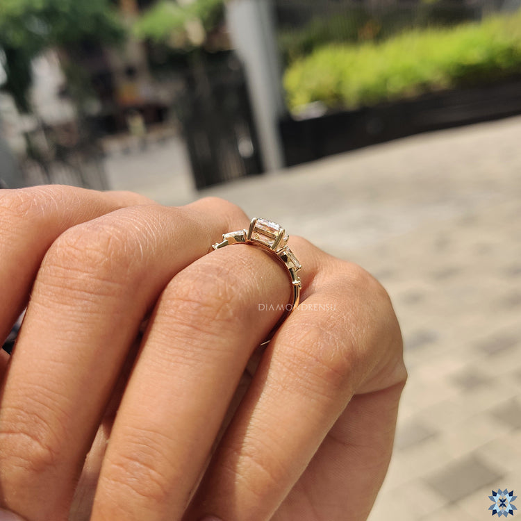 Handmade jewelry featuring moissanite emerald and pear cut stones.