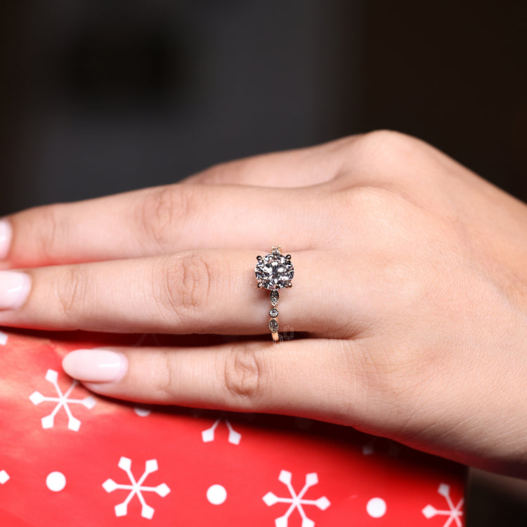 White gold ring featuring a round cut center.