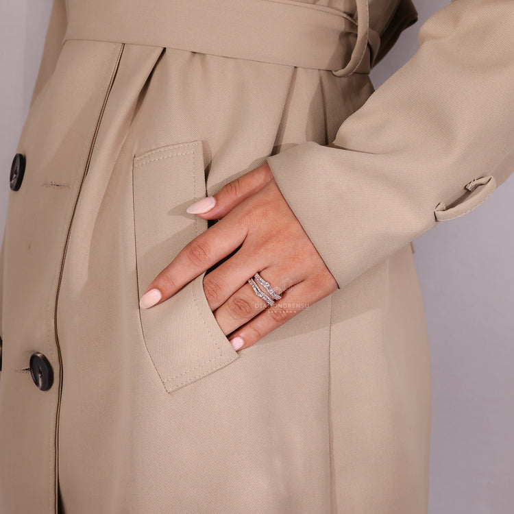 Custom wedding band featuring double curve and prong setting.