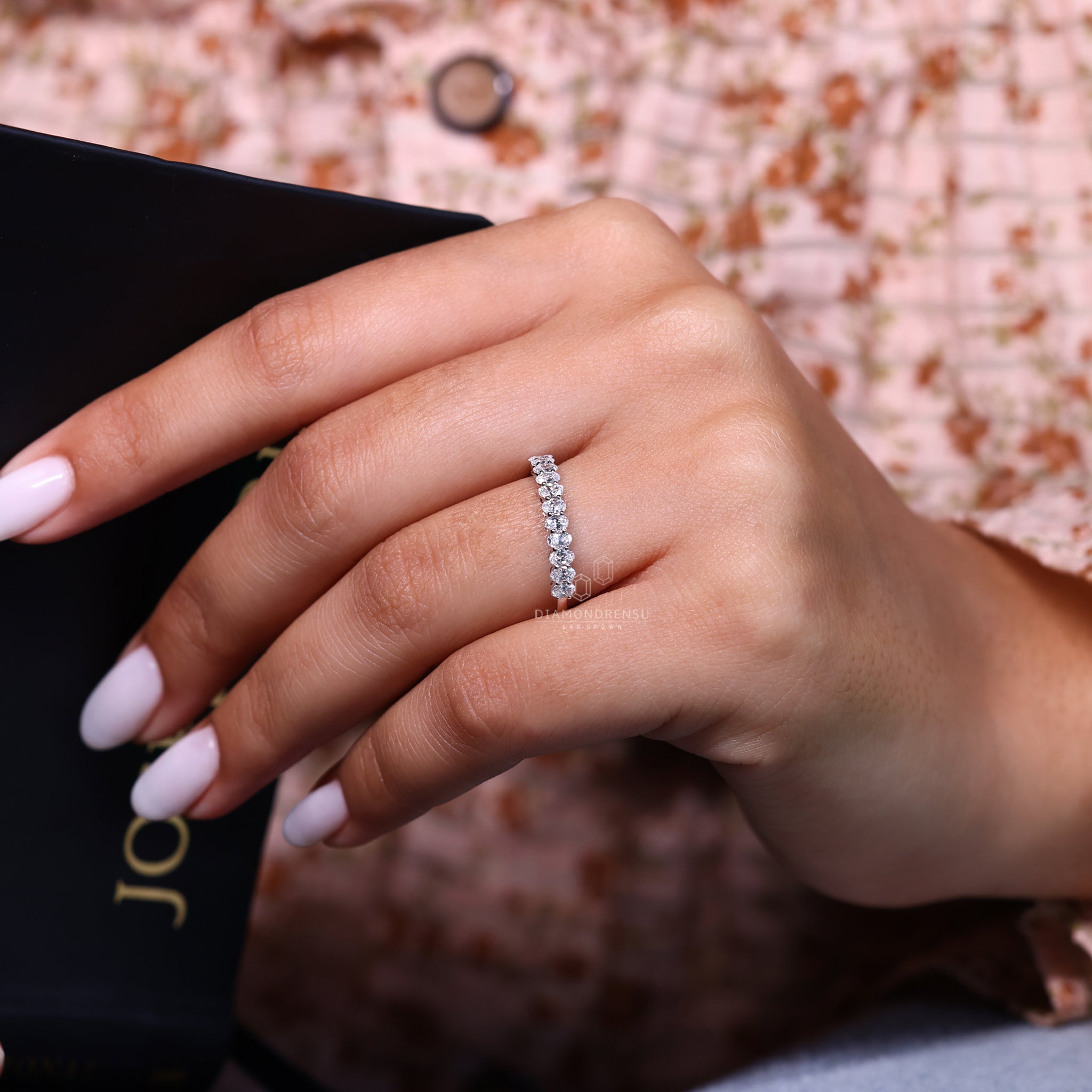 White gold diamond band with prong set oval diamonds.