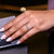 Shared prong setting holds pear cut diamonds securely.
 Shared prong setting holds pear cut diamonds securely.