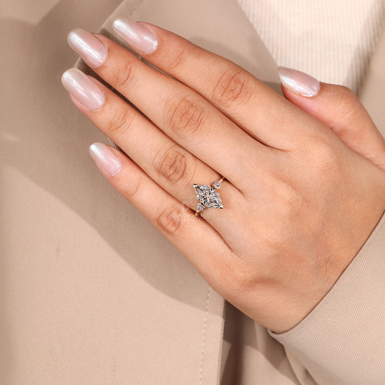 Claw prong setting secures the kite cut side stones.