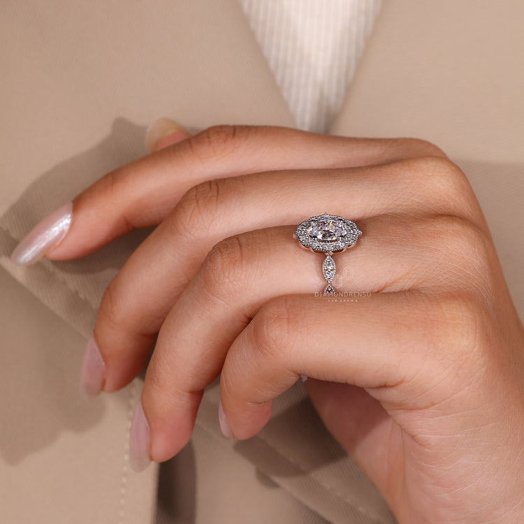 Oval and round diamond ring with vintage detailing.