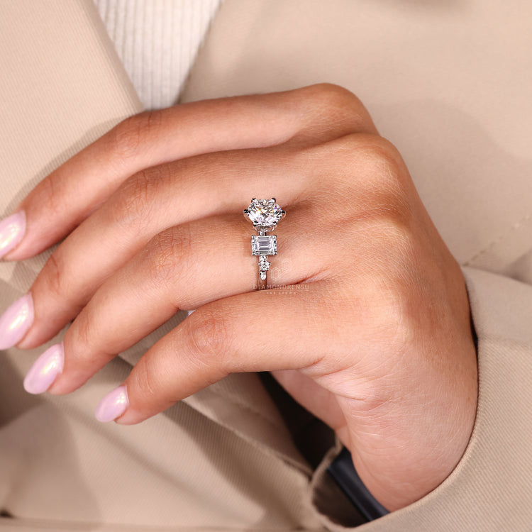 Round cut diamond ring in a six tab prong setting.