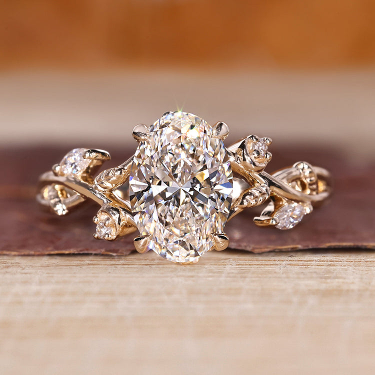 Gold oval diamond engagement ring with marquise and round stones