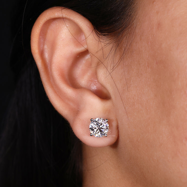Round cut diamond push back earrings.