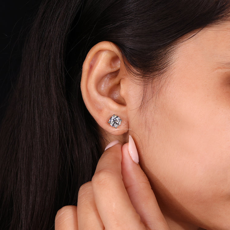 Large round diamond earrings.