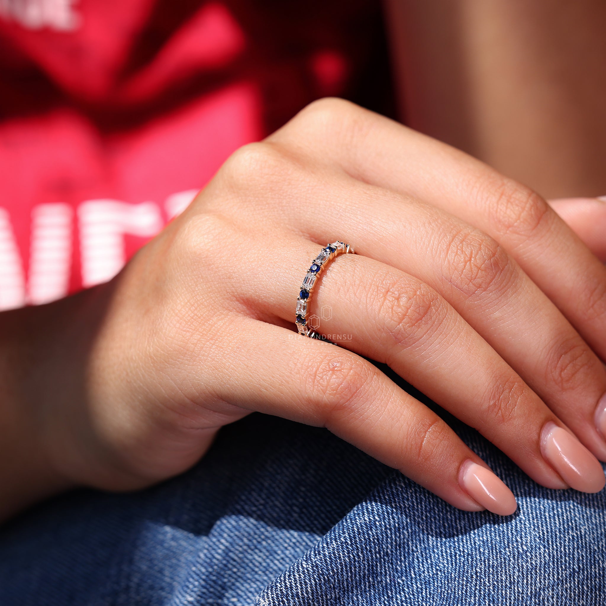 Emerald cut diamond band designed with vivid blue sapphire accents.