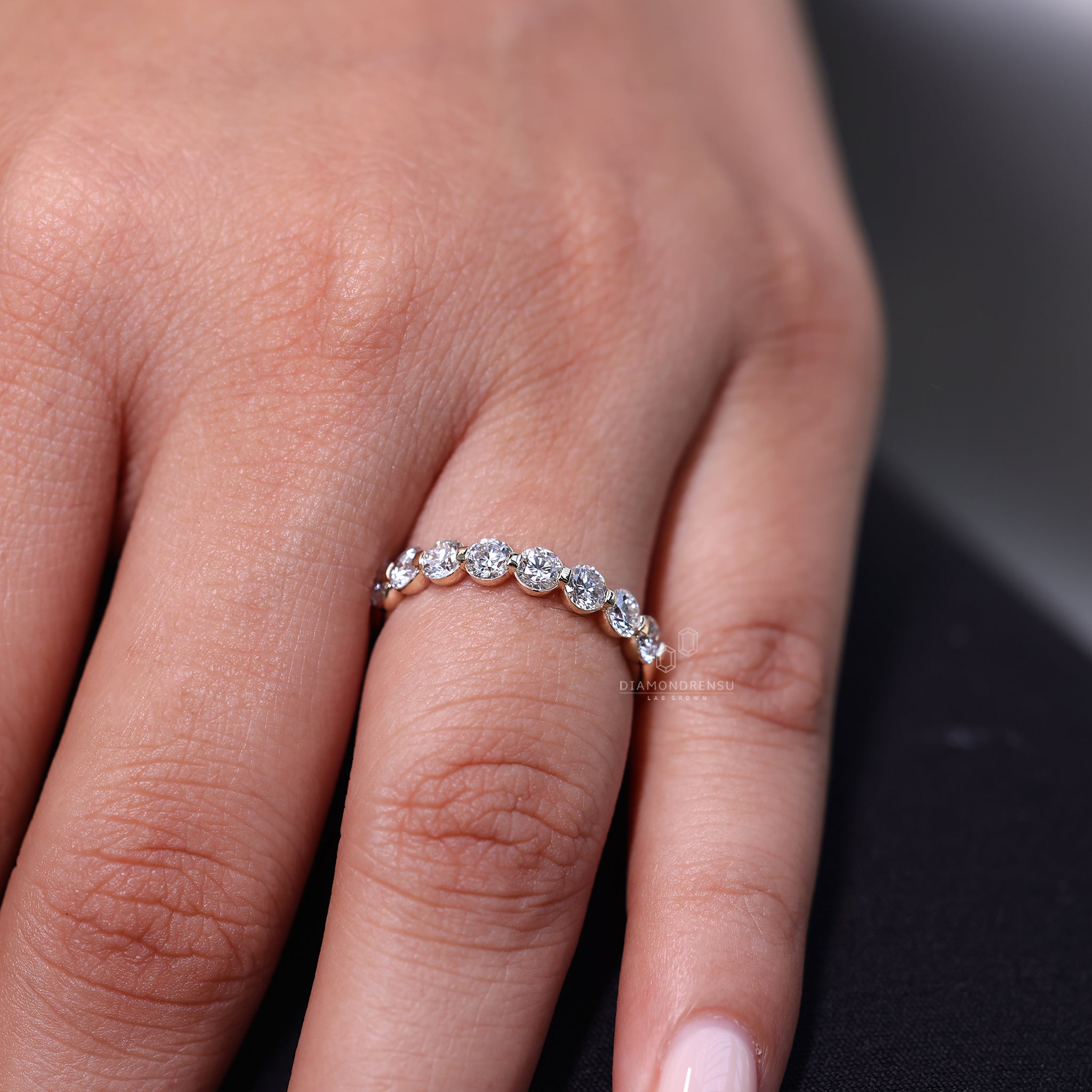 Half eternity wedding band with shared prong set round diamonds.