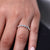 Half eternity wedding band with shared prong set round diamonds. Half eternity wedding band with shared prong set round diamonds.