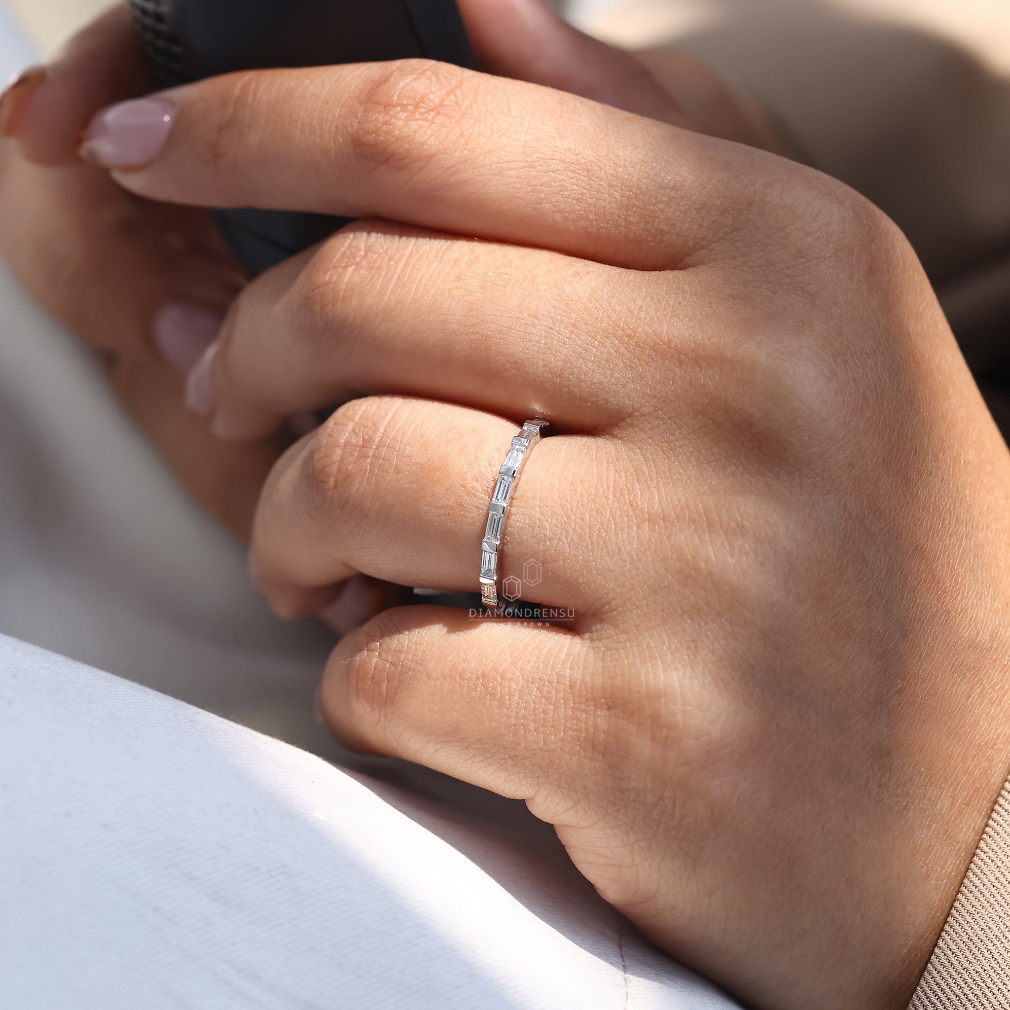 Bar set baguette band designed in sleek white gold.