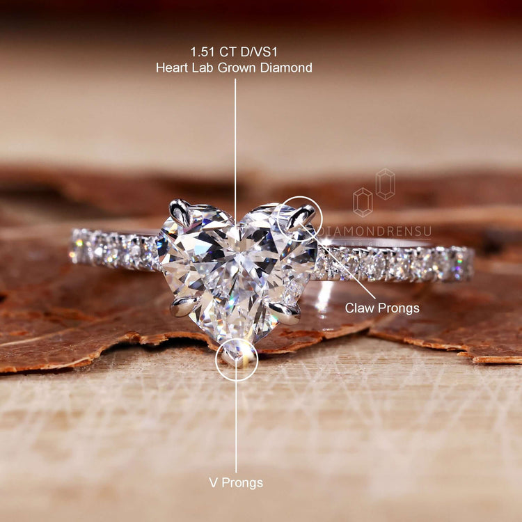 Engagement ring for women with a pave ring diamond design in an elegant heart shaped diamond setting.