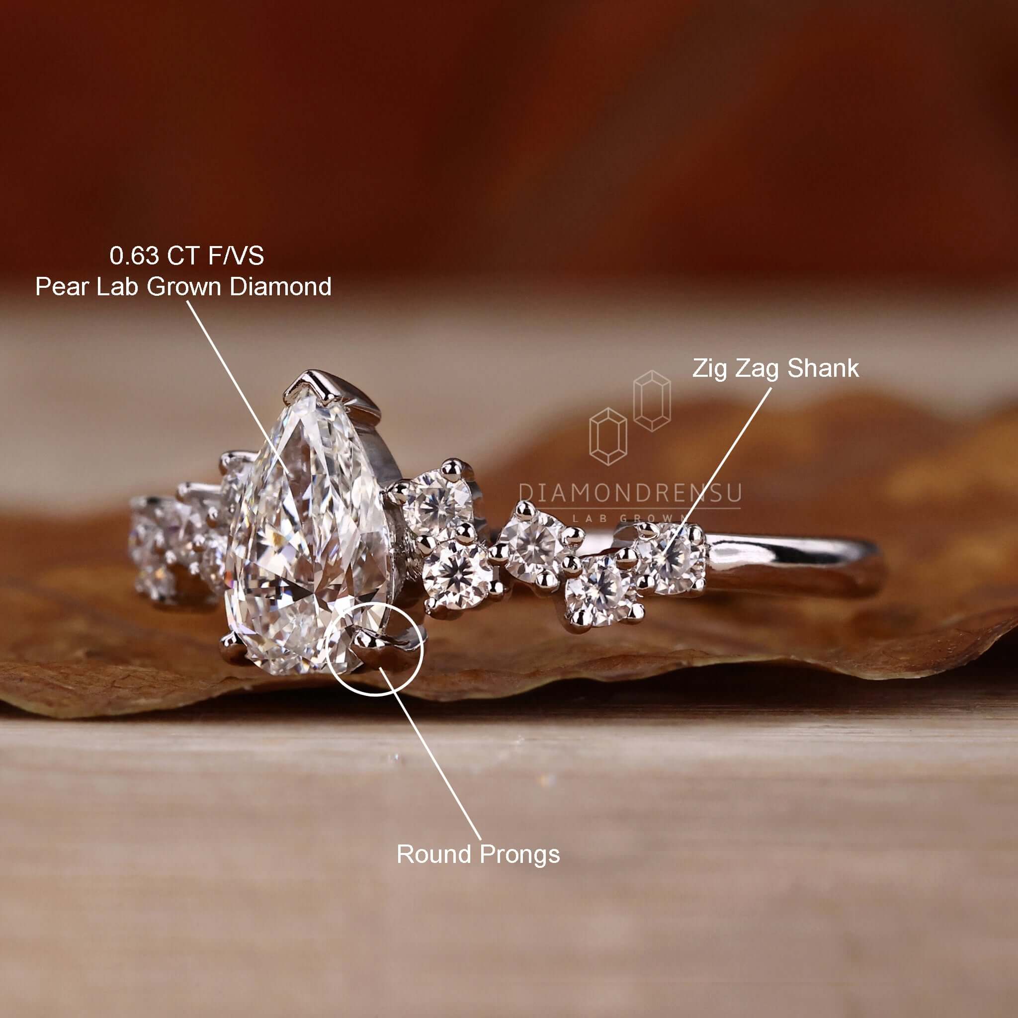 Handmade jewelry featuring a pear cut diamond with round side stones, ideal for an elegant UK engagement ring.