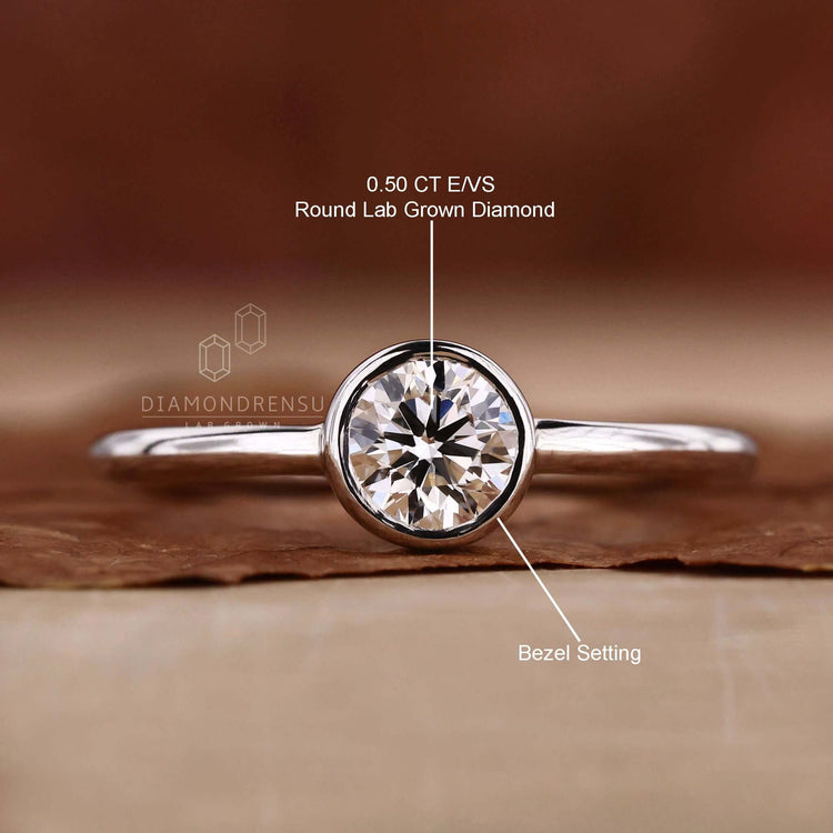 Bezel set round diamond ring with a unique sparkle.