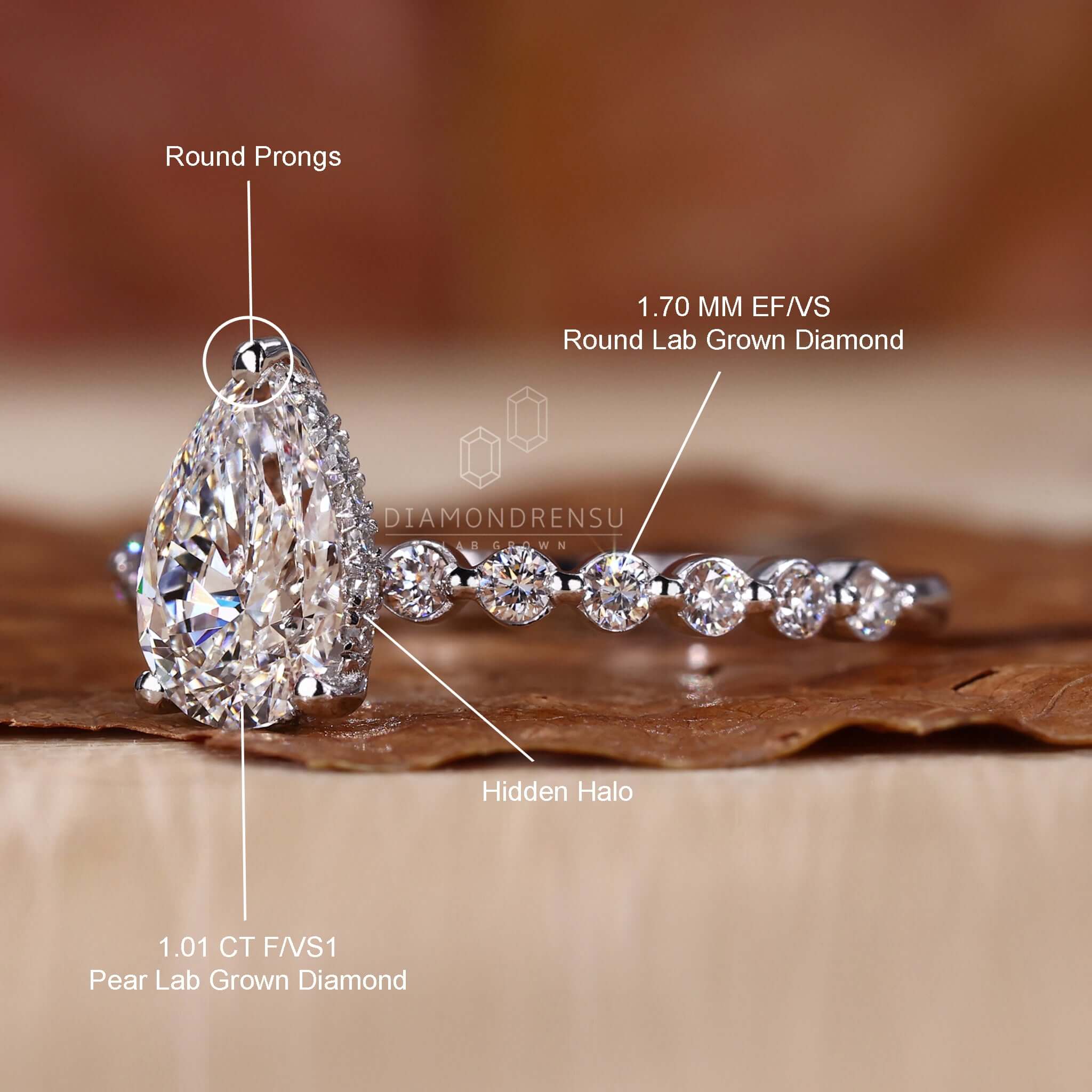 Engagement ring hidden halo with a white gold setting and handcrafted details for a bespoke design.