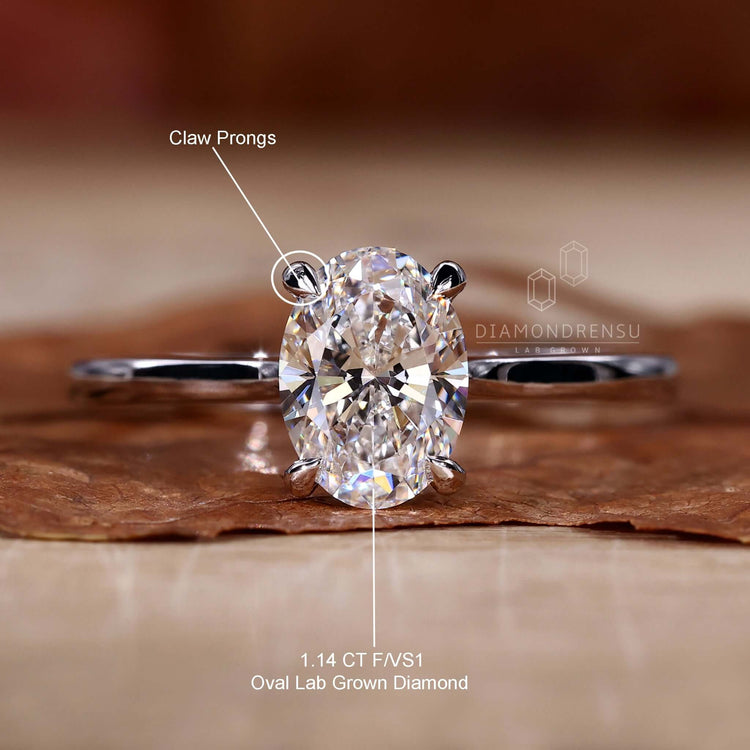 Oval cut solitaire ring in claw prong setting, perfect for engagements.