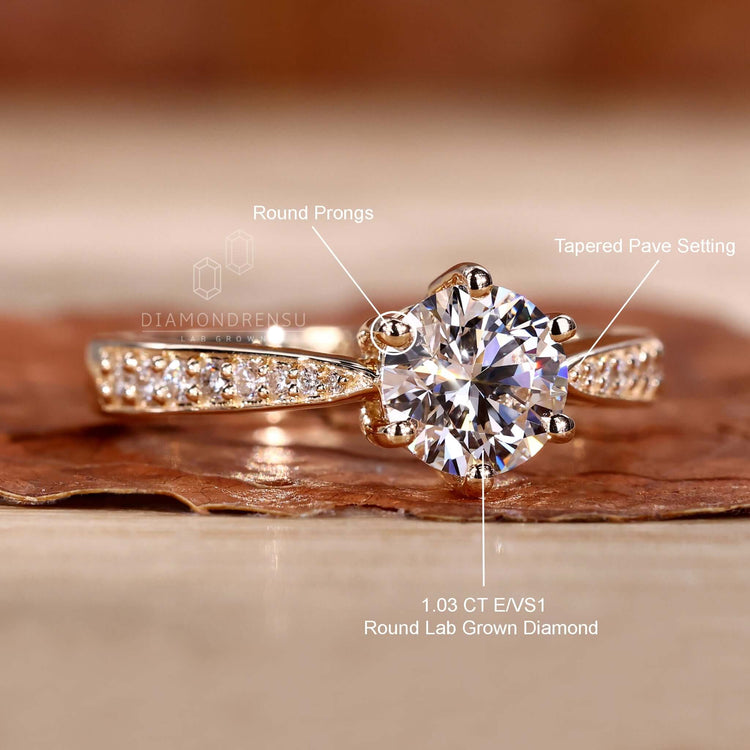 Engagement ring with pave design paired with a round brilliant cut diamond for a radiant finish.