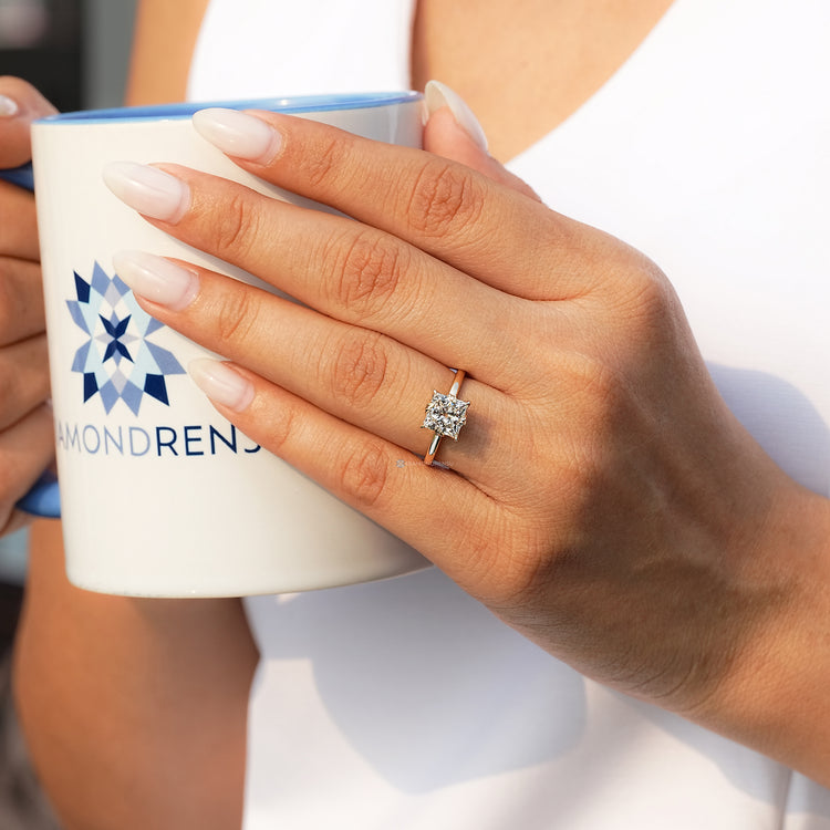 Handmade princess cut ring with four claw prongs.