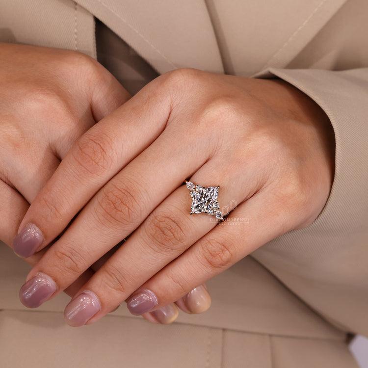 Marquise cut diamond ring with round side accent stones.
