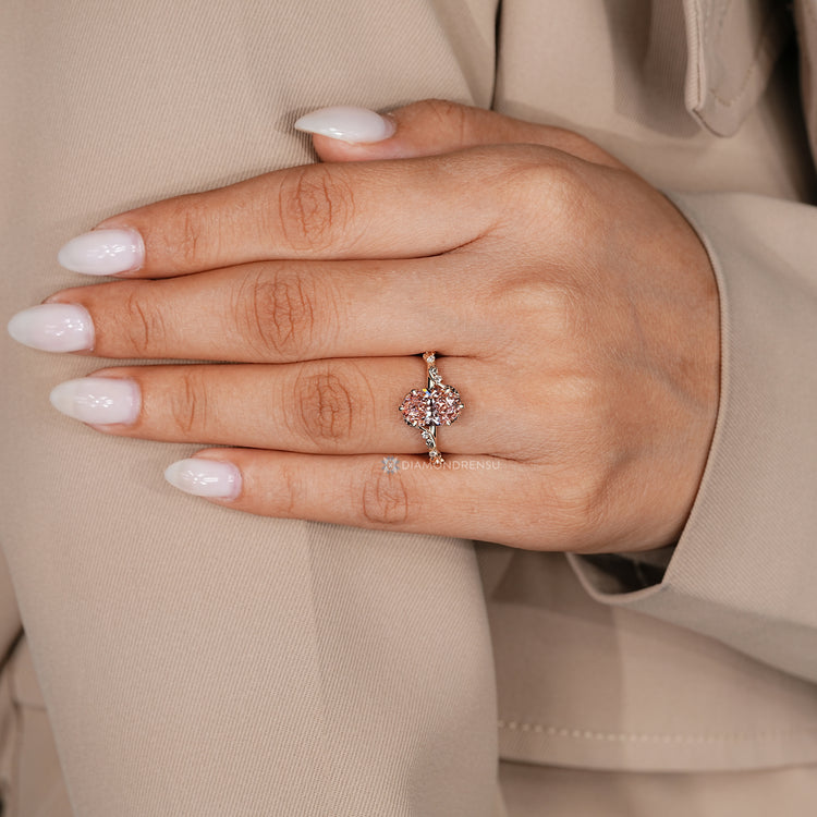 Oval ring with pink centre diamond and tulip setting.