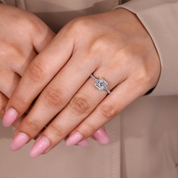 Princess diamond ring with pear side stone detail.