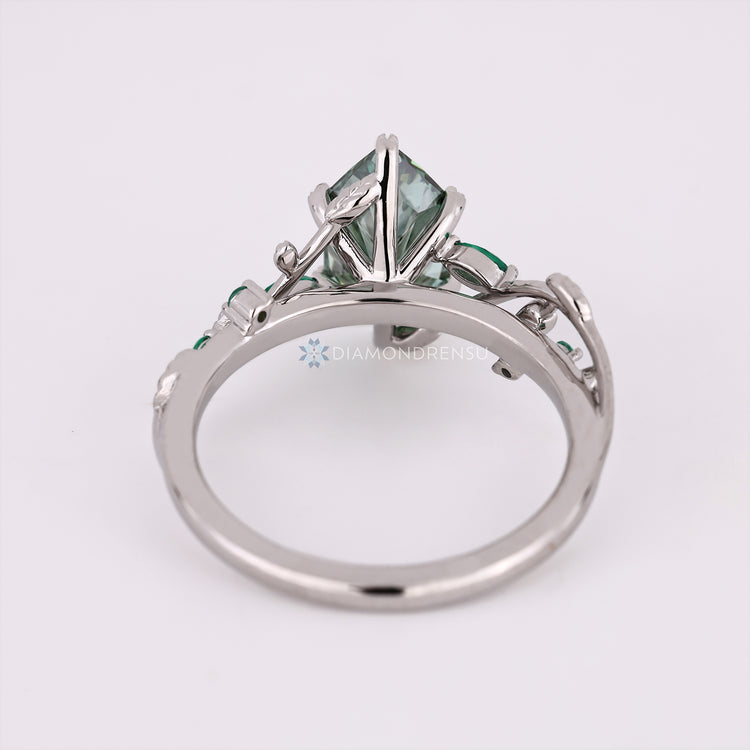 Handmade green marquise diamond ring with six prongs.