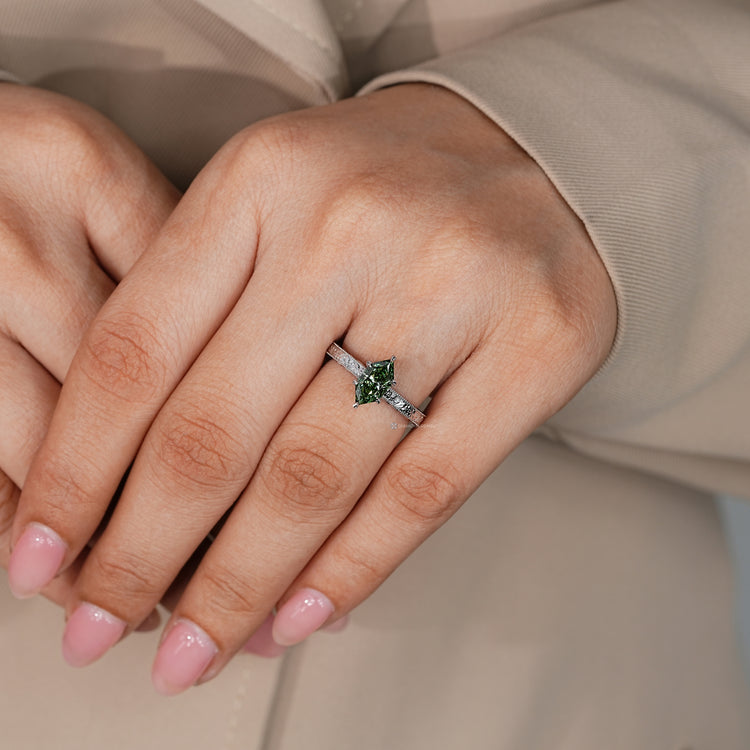Handmade green diamond ring with six leaf style prongs.