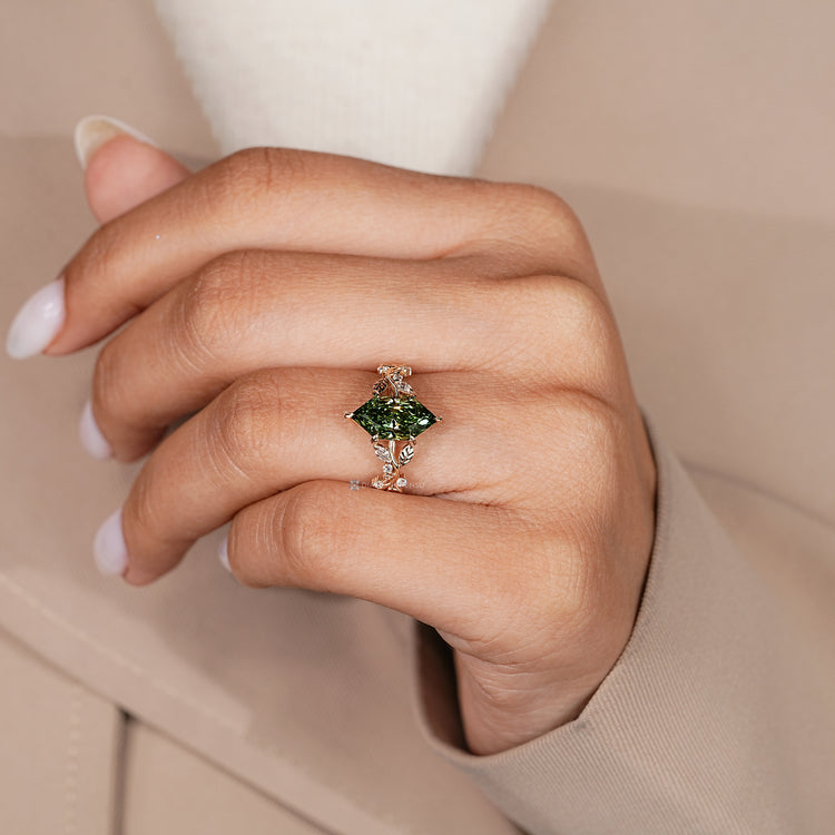 Nature inspired ring with green centre diamond and prongs.