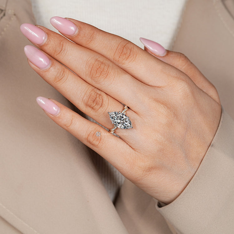Marquise cut engagement ring with two tone style.