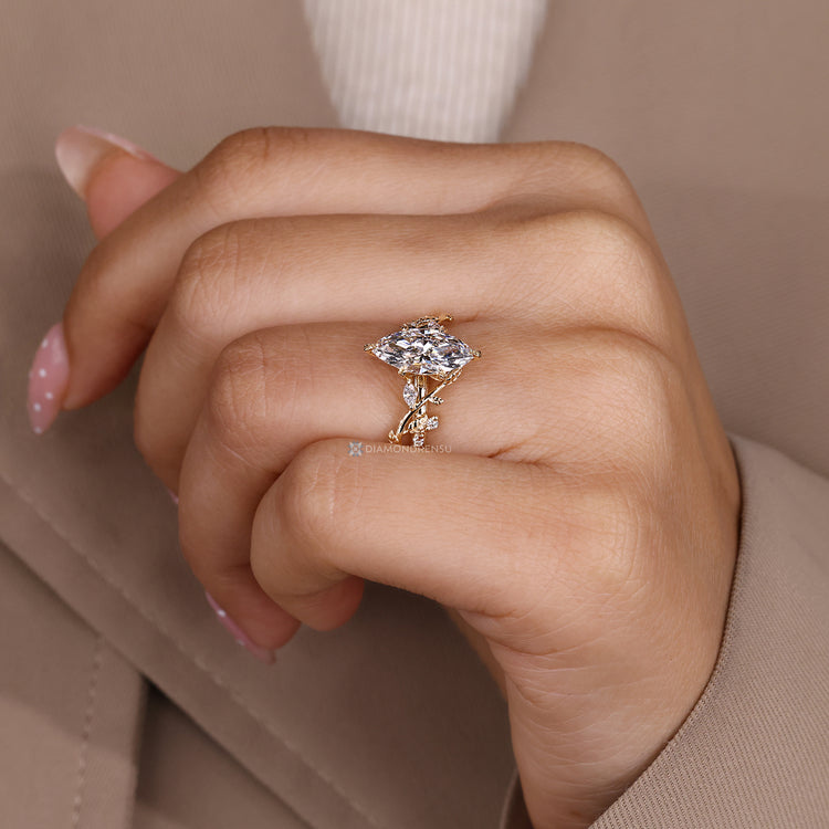 Marquise diamond ring with six leaf style prongs.