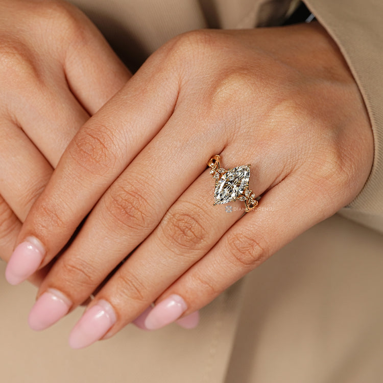Nature inspired diamond ring with six leaf prongs.