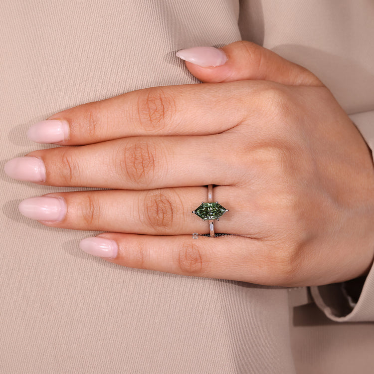 Cathedral setting ring with green marquise diamond.