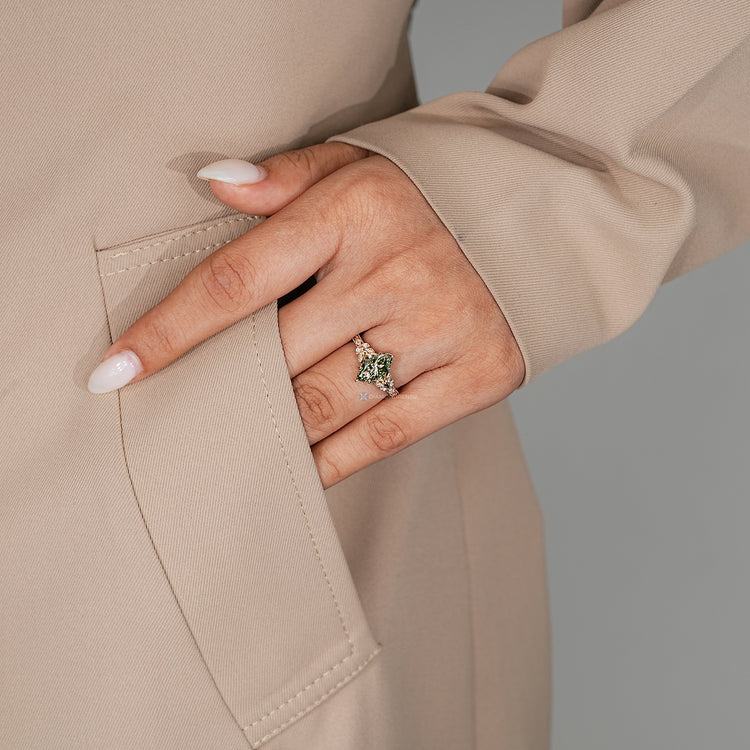 Green diamond ring with split shank and tulip setting.