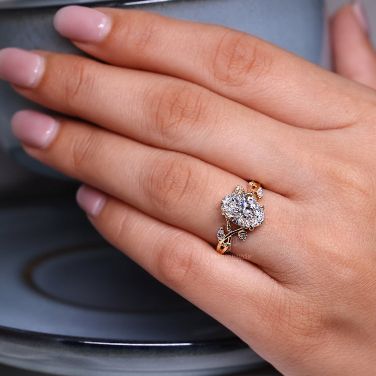 Nature ring with four leaf style prongs and detailing.