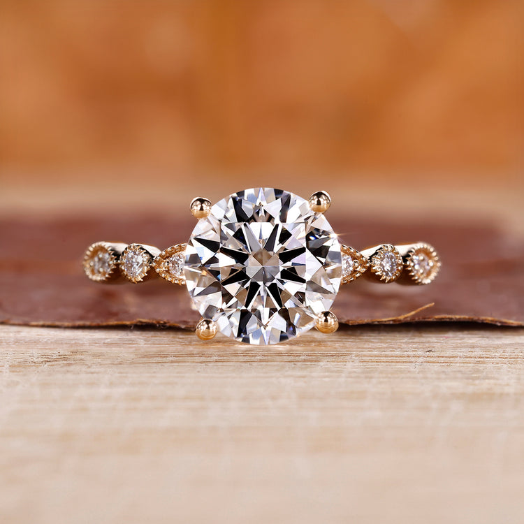 Round cut engagement ring with milgrain details.