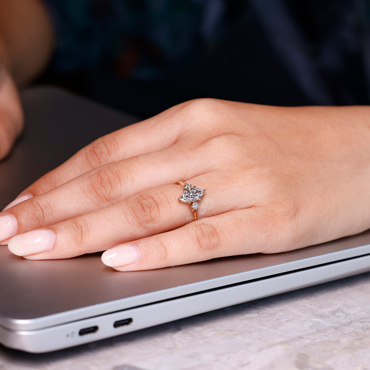 Hidden halo marquise diamond ring with round side stones