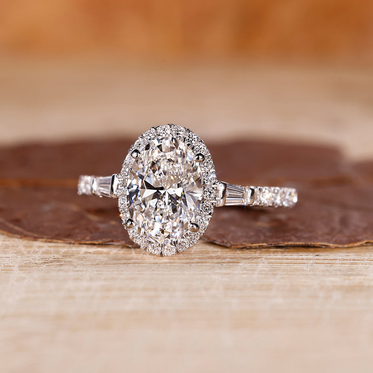 Oval gold diamond engagement ring with tapered baguette diamonds
