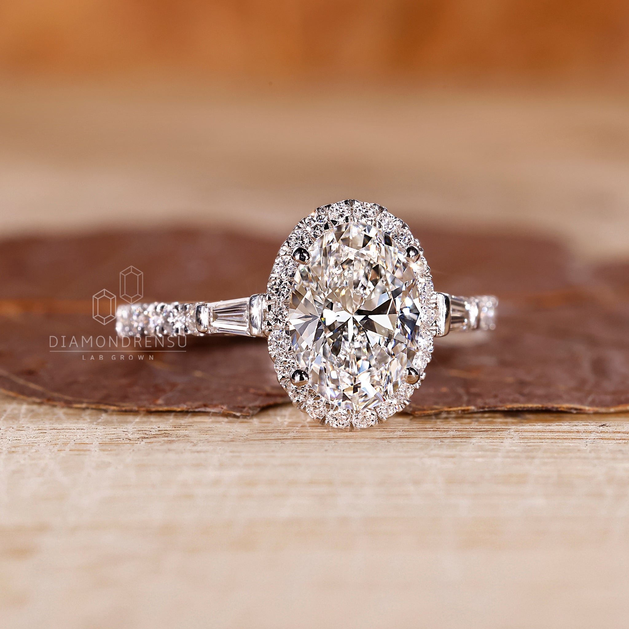 Four prong setting oval diamond ring with baguette accents