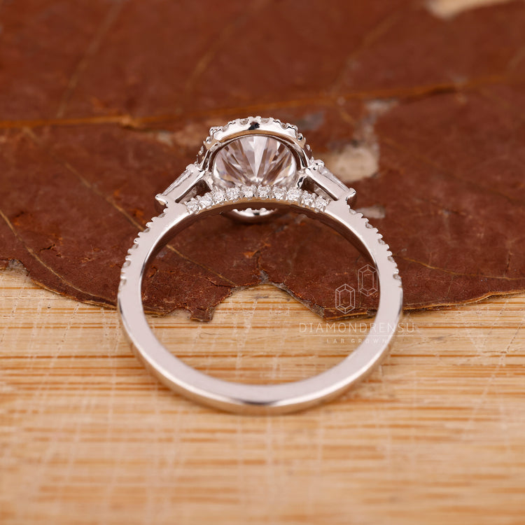 Oval diamond ring with bridge accent in white gold