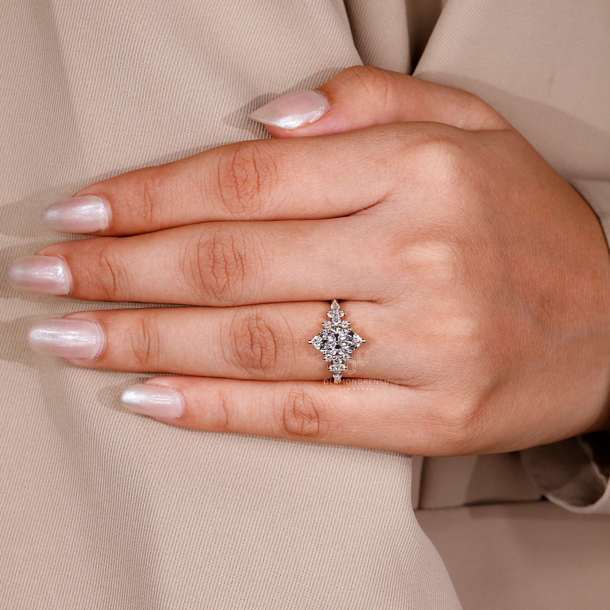 Basket setting ring with pear and round accents.